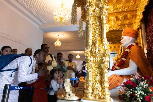 Hindu devotees offer prayers after the consecration ceremony of the BAPS (Bochasanwasi Akshar Purushottam Swaminarayan Sanstha) Hindu temple in Bussy-Saint-Georges on September 6, 2026. On September 6, 2026, thousands of Hindus are celebrating the consecration of the first major temple built in France by the BAPS organization, which promotes it as 'an emblem of Indian culture and Hinduism.' Hailed as the largest Hindu temple built in continental Europe in a traditional style, the edifice stands in the new town of Bussy-Saint-Georges (Seine-et-Marne), 30 km east of the capital. (Photo by Kenzo TRIBOUILLARD / AFP)