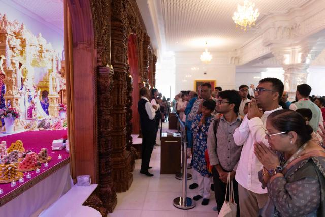 Hindu devotees offer prayers after the consecration ceremony of the BAPS (Bochasanwasi Akshar Purushottam Swaminarayan Sanstha) Hindu temple in Bussy-Saint-Georges on September 6, 2026. On September 6, 2026, thousands of Hindus are celebrating the consecration of the first major temple built in France by the BAPS organization, which promotes it as 'an emblem of Indian culture and Hinduism.' Hailed as the largest Hindu temple built in continental Europe in a traditional style, the edifice stands in the new town of Bussy-Saint-Georges (Seine-et-Marne), 30 km east of the capital. (Photo by Kenzo TRIBOUILLARD / AFP)
