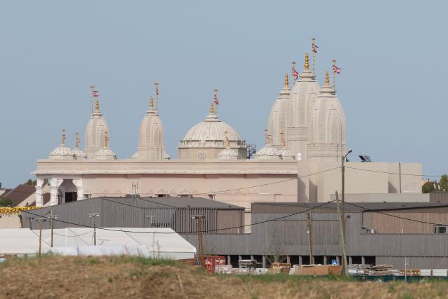 This photograph shows a general view of the newly consecrated BAPS (Bochasanwasi Akshar Purushottam Swaminarayan Sanstha) Hindu temple in Bussy-Saint-Georges on September 6, 2026. On September 6, 2026, thousands of Hindus are celebrating the consecration of the first major temple built in France by the BAPS organization, which promotes it as 'an emblem of Indian culture and Hinduism.' Hailed as the largest Hindu temple built in continental Europe in a traditional style, the edifice stands in the new town of Bussy-Saint-Georges (Seine-et-Marne), 30 km east of the capital. (Photo by Kenzo TRIBOUILLARD / AFP)