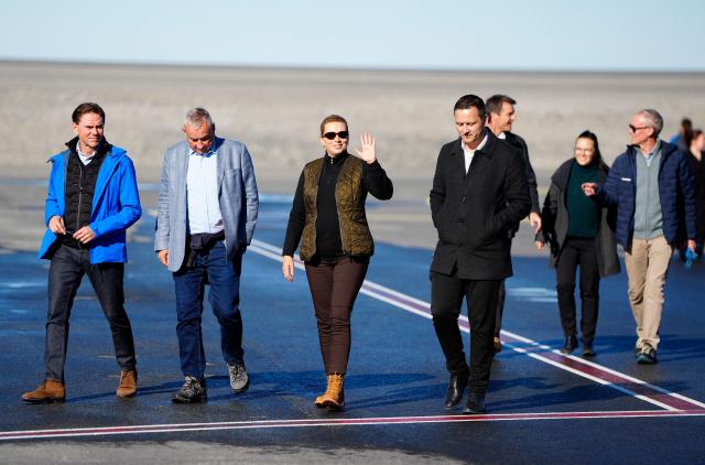 Denmark's Prime Minister Mette Frederiksen (C) waves next to Greenland's Prime Minister Jens-Frederik Nielsen (R) upon arrival in Nuuk, on September 6, 2026. The Prime Minister visits Greenland together with the European Commission President and will, among other things, hold a meeting and go on a boat trip with Greenlandic government leader Jens-Frederik Nielsen. (Photo by Mads Claus Rasmussen / Ritzau Scanpix / AFP) / Denmark OUT
