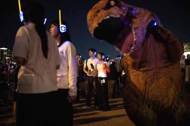 People with headsets gather for a silent disco along the Han River in Seoul on September 6, 2026. (Photo by Lillian SUWANRUMPHA / AFP)