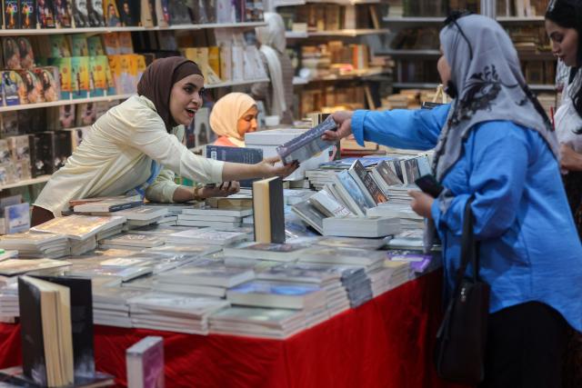 Iraqi women browse books at the Baghdad International Book Fair in Baghdad on September 6, 2026. (Photo by AHMAD AL-RUBAYE / AFP)