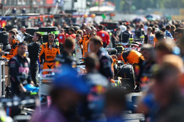Mechanics check the cars in the pit lane following a red flag after the Ferrari's Monegasque driver Charles Leclerc's crash during the Italian Formula One Grand Prix at the Autodromo Nazionale Monza circuit in Monza, northern Italy on September 6, 2026. (Photo by ANNA SZILAGYI / POOL / AFP)