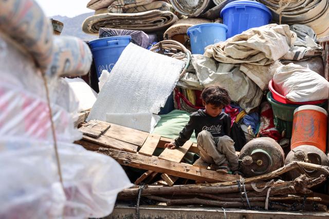 A child plays as internally displaced (IDP) Yemenis who fled their homes due to renewed clashes between Yemen's Saudi-backed government forces and the country's Houthi rebels, unload their belogings and set-up makeshift homes in the al-Kadah area of the Taiz Governorate, southwestern Yemen on September 6, 2026. Fighting between Yemeni government forces and Iran-backed Houthi rebels in southwest Yemen killed more than 140 combatants between midday September 5 to early September 7, military sources said. Two military officials with the Saudi-backed government forces told AFP that 84 of their troops were killed, mostly in missile attacks, while four Houthi military sources said 57 rebel fighters were killed in the same period. (Photo by Ahmad AL-BASHA / AFP)
