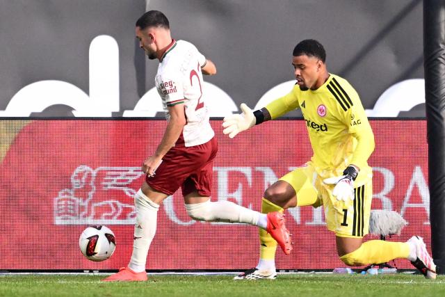 Augsburg's German midfielder #21 Arijon Ibrahimovic (L) and Frankfurt's German goalkeeper #01 Noah Atubolu vie for the ball during the German first division Bundesliga football match between Eintracht Frankfurt and FC Augsburg in Frankfurt am Main, western Germany, on September 6, 2026. (Photo by Kirill KUDRYAVTSEV / AFP) / DFL REGULATIONS PROHIBIT ANY USE OF PHOTOGRAPHS AS IMAGE SEQUENCES AND/OR QUASI-VIDEO