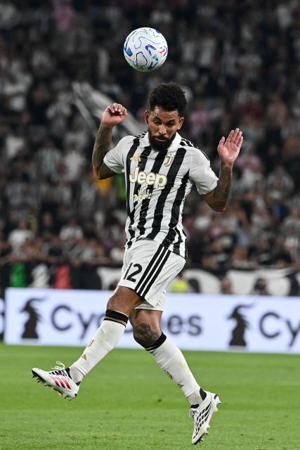 Juventus' Brazilian midfielder #12 Douglas Luiz heads the ball during the Italian Serie A football match between Juventus and AC Milan at the Allianz Stadium in Turin on September 6, 2026. (Photo by Isabella BONOTTO / AFP)