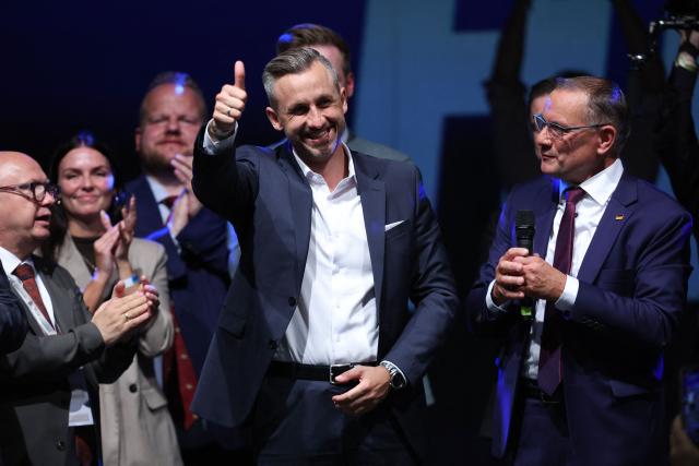 Ulrich Siegmund (C), far-right Alternative for Germany (AfD)'s main candidate in the Saxony-Anhalt state election, gives the thumbs up next to AfD co-leader Tino Chrupalla (R) as they address supporters at the AfD's election party following Saxony-Anhalt's state elections in Magdeburg, eastern Germany on September 6, 2026. Germany's far-right AfD won a landslide victory in a key regional election on September 6 in the ex-communist east, according to exit polls, but it remain unclear whether it can win an absolute majority to govern. (Photo by Ronny HARTMANN / AFP)