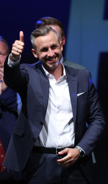 Ulrich Siegmund, far-right Alternative for Germany (AfD)'s main candidate in the Saxony-Anhalt state election, gives the thumbs up as he addresses supporters at the AfD's election party following Saxony-Anhalt's state elections in Magdeburg, eastern Germany on September 6, 2026. Germany's far-right AfD won a landslide victory in a key regional election on September 6 in the ex-communist east, according to exit polls, but it remain unclear whether it can win an absolute majority to govern. (Photo by Ronny HARTMANN / AFP)