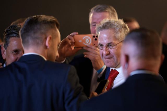 Hans-Georg Maassen (R), former president of the Federal Office for the Protection of the Constitution and former chairman of the right-wing conservative Werteunion party, speaks with Ulrich Siegmund (L), far-right Alternative for Germany (AfD)'s main candidate in the Saxony-Anhalt state election, at the AfD's election party following Saxony-Anhalt's state elections in Magdeburg, eastern Germany on September 6, 2026. Germany's far-right AfD won a landslide victory in a key regional election on September 6 in the ex-communist east, according to exit polls, but it remain unclear whether it can win an absolute majority to govern. (Photo by Ronny HARTMANN / AFP)