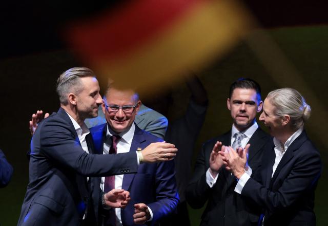 Ulrich Siegmund (L), far-right Alternative for Germany (AfD)'s main candidate in the Saxony-Anhalt state election, reacts with AfD co-leaders Alice Weidel (R) and Tino Chrupalla (2ndL) at the AfD's election party following Saxony-Anhalt's state elections in Magdeburg, eastern Germany on September 6, 2026. Germany's far-right AfD won a landslide victory in a key regional election on September 6 in the ex-communist east, according to exit polls, but it remain unclear whether it can win an absolute majority to govern. (Photo by Ronny HARTMANN / AFP)