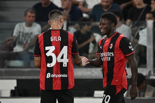 AC Milan's Italian midfielder #70 Alphadjo Cisse celebrates with AC Milan's Spanish defender #34 Mario Gila after scoring his team's first goal during the Italian Serie A football match between Juventus and AC Milan at the Allianz Stadium in Turin on September 6, 2026. (Photo by Isabella BONOTTO / AFP)