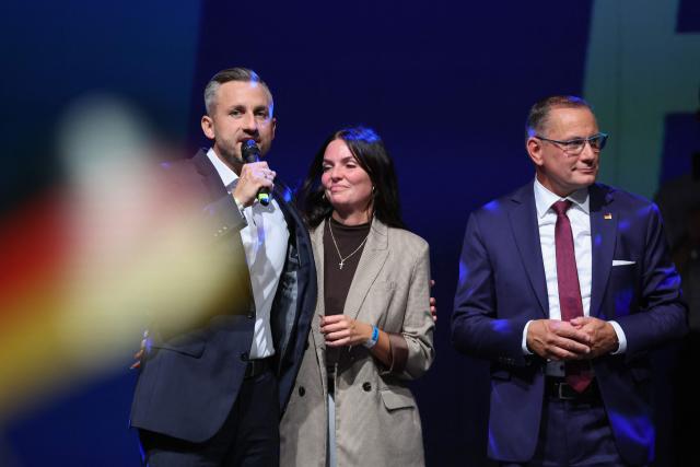 Ulrich Siegmund (L), far-right Alternative for Germany (AfD)'s main candidate in the Saxony-Anhalt state election, addresses supporters next to his wife Julia Siegmund and AfD co-leader Tino Chrupalla (R) at the AfD's election party following Saxony-Anhalt's state elections in Magdeburg, eastern Germany on September 6, 2026. Germany's far-right AfD won a landslide victory in a key regional election on September 6 in the ex-communist east, according to exit polls, but it remain unclear whether it can win an absolute majority to govern. (Photo by Ronny HARTMANN / AFP)
