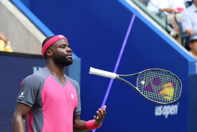 USA's Frances Tiafoe tosses his racquet as he plays Russia's Daniil Medvedev in their men's singles round of 16 tennis match on day eight of the US Open tennis tournament at the USTA Billie Jean King National Tennis Center in New York on September 6, 2026. (Photo by Leonardo MUNOZ / AFP)