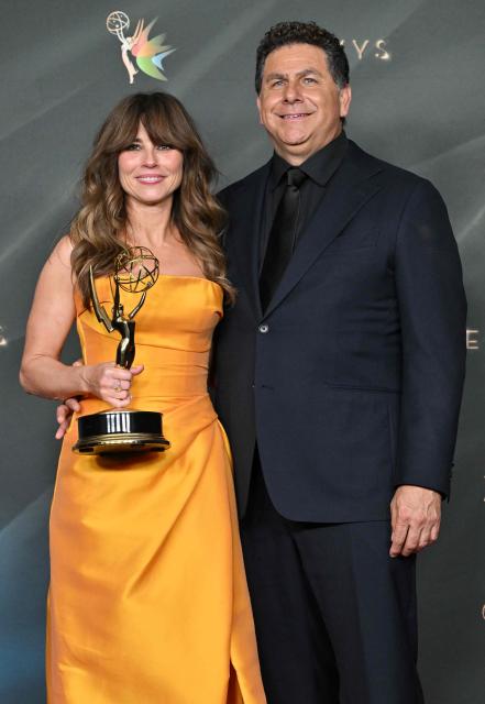 US actress Linda Cardellini, winner of Outstanding Supporting Actress in a Limited or Anthology Series or Movie for "DTF St. Louis" poses with her partner director Steve Rodriguez during Night Two of the 78th Emmy Awards at the Peacock Theater in Los Angeles on September 6, 2026. (Photo by LISA O'CONNOR / AFP)