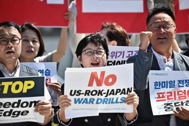Members of the Korean Peace Solidarity for Sovereignty and Reunification protest against the South Korea, US and Japan trilateral joint military exercise “Freedom Edge”, in front of the US Embassy in Seoul on September 7, 2026. (Photo by Lillian SUWANRUMPHA / AFP)