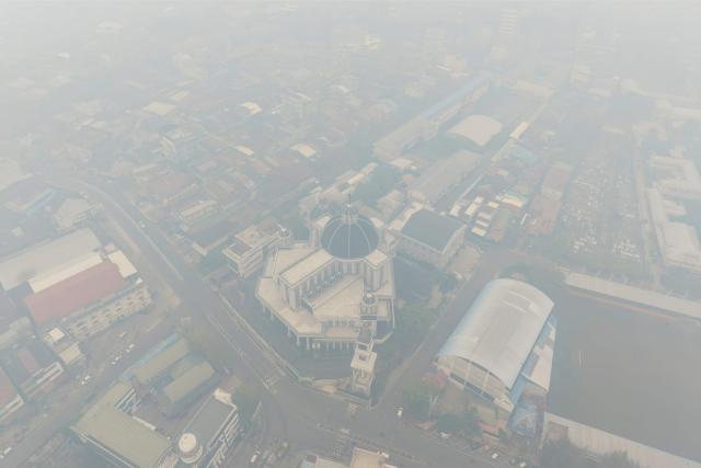 This aerial picture shows haze from land and forest fires blanketing the Cathedral Church in the city of Pontianak, West Kalimantan, on September 7, 2026. (Photo by BAY ISMOYO / AFP)