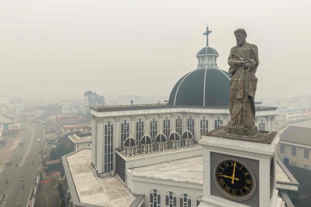 This aerial picture shows haze from land and forest fires blanketing the Cathedral Church in the city of Pontianak, West Kalimantan, on September 7, 2026. (Photo by BAY ISMOYO / AFP)