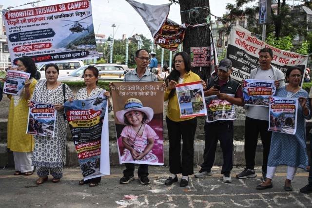Relatives and family members of the missing victims of the August 26 flash floods hold posters as they protest to urge the government to intensify search efforts, in Kathmandu on September 7, 2026. The August 26 glacial and mountain collapse on the China-Nepal border killed at least 1,385 people, with more than 5,500 missing across the two countries. (Photo by PRAKASH MATHEMA / AFP)