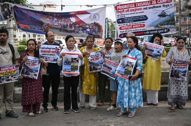 Relatives and family members of the missing victims of the August 26 flash floods hold posters as they protest to urge the government to intensify search efforts, in Kathmandu on September 7, 2026. The August 26 glacial and mountain collapse on the China-Nepal border killed at least 1,385 people, with more than 5,500 missing across the two countries. (Photo by PRAKASH MATHEMA / AFP)