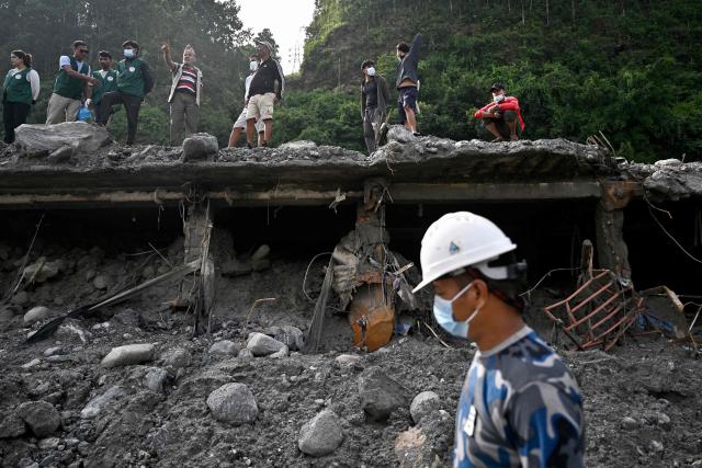 A police rescue worker operates in the aftermath of flash floods at Trishuli in Nepal's Nuwakot district on September 7, 2026. The August 26 glacial and mountain collapse on the China-Nepal border killed at least 1,385 people, with more than 5,500 missing across the two countries. (Photo by Pedro PARDO / AFP)