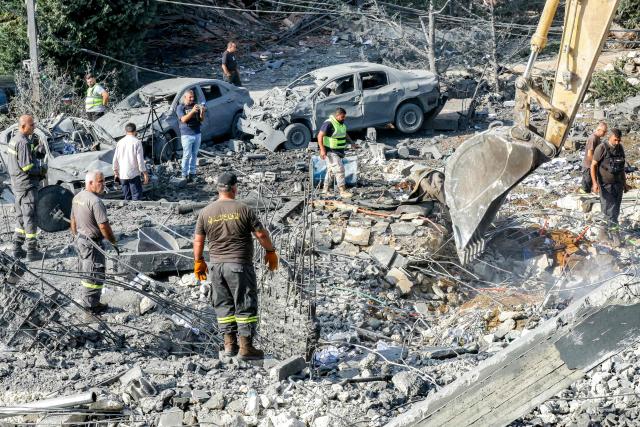 An excavator digs as rescuers search for survivors amidst the rubble following an overnight Israeli airstrike on the village of Kfar Roummane in southern Lebanon on September 7, 2026. Lebanese state media on September 7 reported that Israeli strikes overnight killed 11 people, including two infants, a day after separate raids left seven dead. (Photo by Mahmoud ZAYYAT / AFP) / 