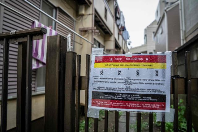A notice warning against illegal garbage dumping, written in multiple languages, is seen outside an apartment building near Shinjuku Station in Tokyo on September 7, 2026. Tokyo tourist hotspot Shinjuku will impose a ban on more than half of its holiday rentals including homes on Airbnb, an official said on September 7, after a surge in complaints about visitors. (Photo by Yuichi YAMAZAKI / AFP)