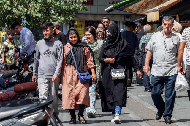 People walk along a market street in Tehran on September 7, 2026. Iran's top negotiator threatened on September 6 of a more forceful response to any further US attacks after Tehran targeted American warships in their latest round of clashes. The exchanges of fire, which began with US raids last week, come amid a deadlock in the six-month war between the two foes. (Photo by AFP) / 