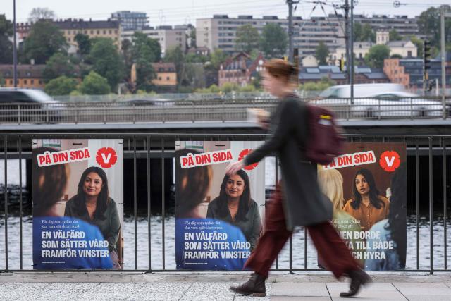 A pedestrian walks past election campaign posters featuring Left Party leader Nooshi Dadgostar in central Stockholm, Sweden, on September 7, 2026, ahead of Sweden’s general election on September 13. (Photo by Jonathan NACKSTRAND / AFP)