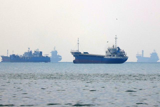 Vessels transit the Hormuz Strait off the coast of Iran's southern port city of Bandar Abbas on September 7, 2026. Iran's top negotiator threatened on September 6 of a more forceful response to any further US attacks after Tehran targeted American warships in their latest round of clashes. The exchanges of fire, which began with US raids last week, come amid a deadlock in the six-month war between the two foes. (Photo by ATTA KENARE / AFP) / 