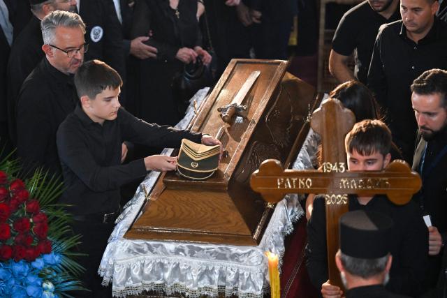 Darko Mladic (L), son of late Bosnian Serb military leader Ratko Mladic mourns next to the coffin of his father during the funeral ceremony for Ratko Mladic at St Lukas church in Belgrade on September 7, 2026. Mladic, 84, died last week after suffering several strokes while serving a life sentence in The Hague for war crimes committed during the 1990s war in Bosnia. (Photo by OLIVER BUNIC / AFP)