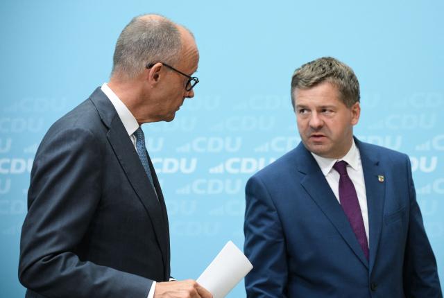 German Chancellor and leader of Germany's Christian Democratic Union (CDU) Friedrich Merz (L) and Saxony-Anhalt's State Premier Sven Schulze talk after a press conference following the party's leadership meeting in Berlin on September 7, 2026, one day after regional elections in the eastern federal state of Saxony-Anhalt. (Photo by RALF HIRSCHBERGER / AFP)