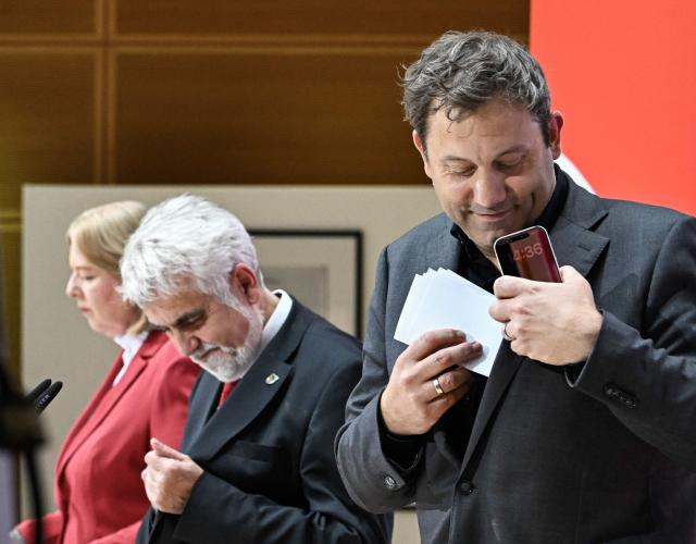 Chairman of the Germany's Social Democratic Party (SPD) and Vice-Chancellor Lars Klingbeil (R) gets up, as Armin Willingmann (C), top candidate of the social democratic SPD party for regional elections in Sachsen-Anhalt, and SPD co-leader Baerbel Bas (L) sit at the end of a press conference following an SPD leadership meeting in Berlin on September 7, 2026, one day after regional elections in the eastern federal state of Saxony-Anhalt. (Photo by Tobias SCHWARZ / AFP)
