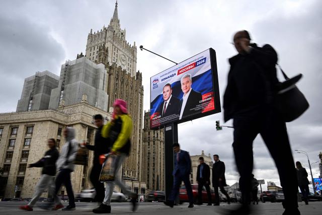 Pedestrians walk past the Russian Foreign Ministry building and a campaign poster, depicting Moscow mayor Sergei Sobyanin (R) and Duma's Vice Speaker Pyotr Tolstoy, for the election to the Russian State Duma (lower house of Russia's Parliament) in Moscow on September 7, 2026. Russia will vote for the Duma's election on September 18-20, 2026. (Photo by Alexander NEMENOV / AFP)