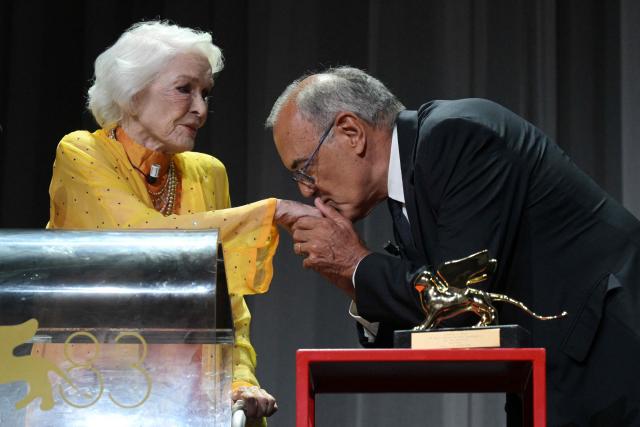 Director of Venice Film Festival Alberto Barbera kisses the hand of US actress Ellen Burstyn as she receives the Golden Lion for Lifetime Achievement during the 83rd International Venice Film Festival, on September 7, 2026 at Venice Lido. (Photo by Tiziana FABI / AFP)