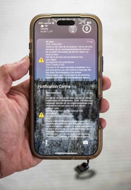 A mobile phone displays test messages from SE-Alert, including an “all clear” notification marking the end of the test, in Stockholm, Sweden, on September 7, 2026. The Swedish Civil Defence and Resilience Agency carried out a nationwide test of the system on September 7, 2026. (Photo by Jonathan NACKSTRAND / AFP)
