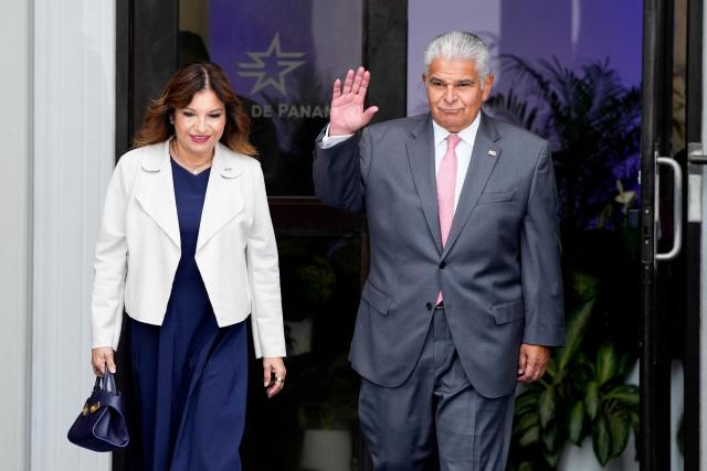 Panama's President Jose Raul Mulino waves alongside his wife, Maricel Cohen de Mulino, as they arrive at the inauguration ceremony for the new Panama Canal Administrador at the Administration building in Panama City on September 7, 2026. Marotta assumes the administration of the Panama Canal for the 2026-2033 period, becoming the first woman to lead the interoceanic waterway. (Photo by ARNULFO FRANCO / AFP)