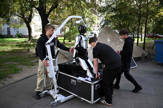 Technicians pack a humanoid robot into a box after a demonstration calling for the regulation of artificial intelligence development in Warsaw on September 7, 2026. Waving flags, "chanting" slogans, and marching in circles -- around thirty robots took to the streets to raise awareness for AI regulation in front of the digital affairs ministry on September 7, 2026. (Photo by Sergei GAPON / AFP)