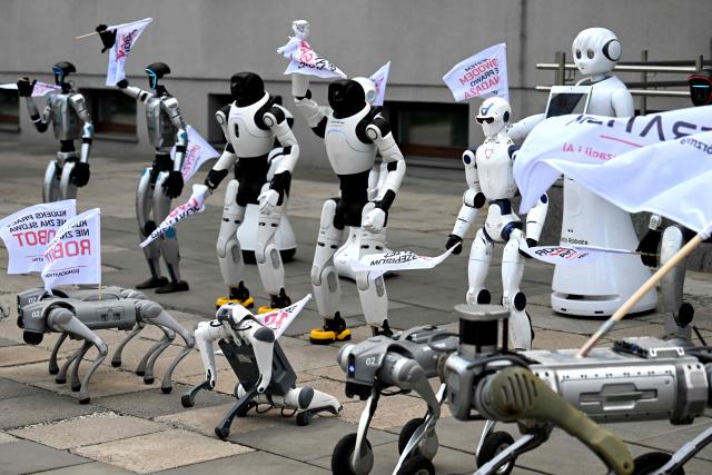 Humanoid and quadruped robots are seen during a demonstration calling for the regulation of artificial intelligence development in Warsaw on September 7, 2026. Waving flags, "chanting" slogans, and marching in circles -- around thirty robots took to the streets to raise awareness for AI regulation in front of the digital affairs ministry on September 7, 2026. (Photo by Sergei GAPON / AFP)