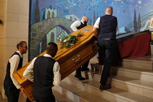 Pallbearers carry the coffin towards the altar ahead of the funeral ceremony of Jean-Francois Leroy, founder and longtime director of the Visa pour l'Image international photojournalism festival, at the Pere Lachaise cemetery in Paris on September 7, 2026. Jean-Francois Leroy passed away of cancer at the age of 69 on August 31, 2026 at the start of the 38th edition of the Visa pour l'Image photojournalism festival in Perpignan, which he founded in 1989. (Photo by GEOFFROY VAN DER HASSELT / AFP)
