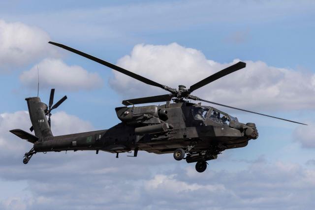 A Polish Air Forces' US-made AH-6h Apache helicopter flies during a demonstration of Polish Army training at the military training ground in Nowa Deba, Poland on September 7, 2026, on the eve of the 34th International Defence Industry Exhibition. The 34th International Defence Industry Exhibition runs from September 8 to 11, 2026 in Kielce, Poland. (Photo by Wojtek RADWANSKI / AFP)