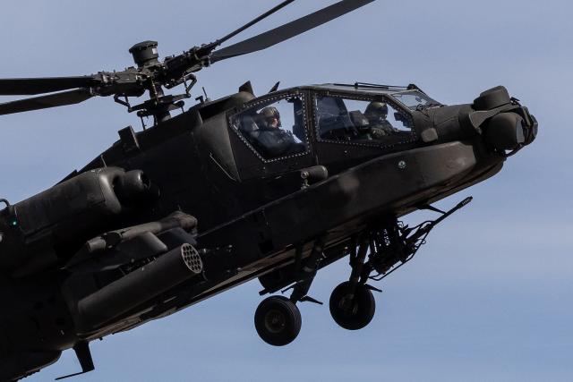 A Polish Air Forces US-made AH-6h Apache helicopter flies during a demonstration of Polish Army training at the military training ground in Nowa Deba, Poland on September 7, 2026, on the eve of the 34th International Defence Industry Exhibition. The 34th International Defence Industry Exhibition runs from September 8 to 11, 2026 in Kielce, Poland. (Photo by Wojtek RADWANSKI / AFP)