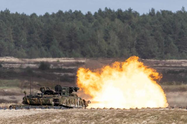 A Polish Army's Germany-made Leopard 2PL tankdrives in front of fire blast during a demonstration of Polish Army training at the military training ground in Nowa Deba, Poland on September 7, 2026, on the eve of the 34th International Defence Industry Exhibition. The 34th International Defence Industry Exhibition runs from September 8 to 11, 2026 in Kielce, Poland. (Photo by Wojtek RADWANSKI / AFP)
