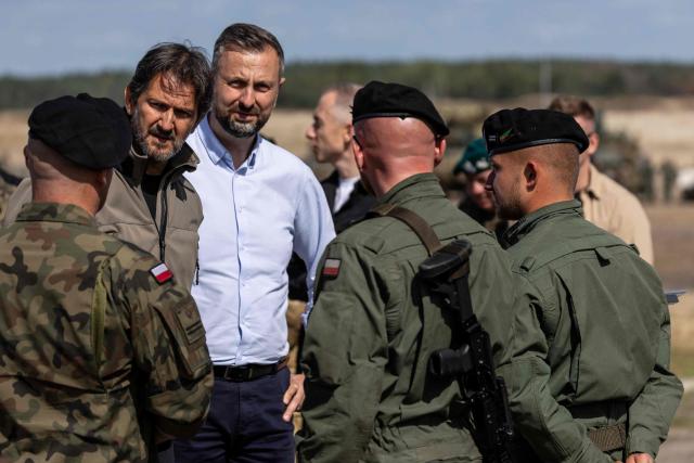 Poland's Deputy Prime Minister and Minister of Defence Wladyslaw Kosiniak-Kamysz (3-L) and Slovakia's Deputy Prime Minister and Minister of Defence Robert Kalinak (2-L) talk to Polish soldiers after a demonstration of Polish Army training at the military training ground in Nowa Deba, Poland on September 7, 2026, on the eve of the 34th International Defence Industry Exhibition. The 34th International Defence Industry Exhibition runs from September 8 to 11, 2026 in Kielce, Poland. (Photo by Wojtek RADWANSKI / AFP)