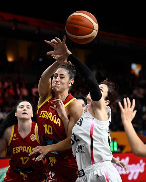 Spain's small forward #10 Maria Conde (C) and Spain's center #17 Megan Gustafson (L) vie for the ball with Japan's power forward #52 Yuki Miyazawa2 during the 2026 FIBA Women's Basketball World Cup Group A match between Japan and Spain at the Berlin Arena in Berlin on September 7, 2026. (Photo by Tobias SCHWARZ / AFP)