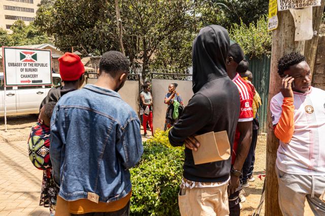 TOPSHOT - Burundian nationals gather outside their embassy to apply for border passes as they prepare to travel back to their country following the Kenyan government’s directive on undocumented small-scale traders, in Nairobi on September 7, 2026. With less than a year to go before presidential and legislative elections in which his re-election is not guaranteed, William Ruto called on September 2 for the closure on Monday "of all small businesses" run by foreigners in Kenya, during a meeting with Kenyan entrepreneurs. (Photo by SIMON MAINA / AFP)