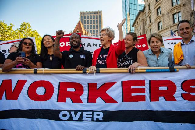 Politicians and organizers including Boston Mayor Michelle Wu (2L), US Senator Elizabeth Warren, Democrat from Massachusetts (C) and Massachusetts Governor Maura Healey (2R) march together during the Boston Labor Day Parade in Boston, Massachusetts on September 7, 2026.  (Photo by JOSEPH PREZIOSO / AFP)