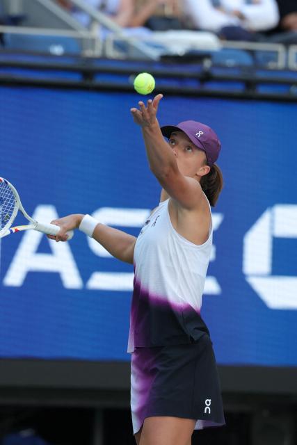 Poland's Iga Swiatek serves to China's Qinwen Zheng during their women's singles round of 16 tennis match on day nine of the US Open tennis tournament at the USTA Billie Jean King National Tennis Center in New York City on September 7, 2026. (Photo by KENA BETANCUR / AFP)