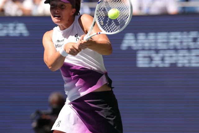 Poland's Iga Swiatek hits a return against China's Qinwen Zheng during their women's singles round of 16 tennis match on day nine of the US Open tennis tournament at the USTA Billie Jean King National Tennis Center in New York City on September 7, 2026. (Photo by KENA BETANCUR / AFP)