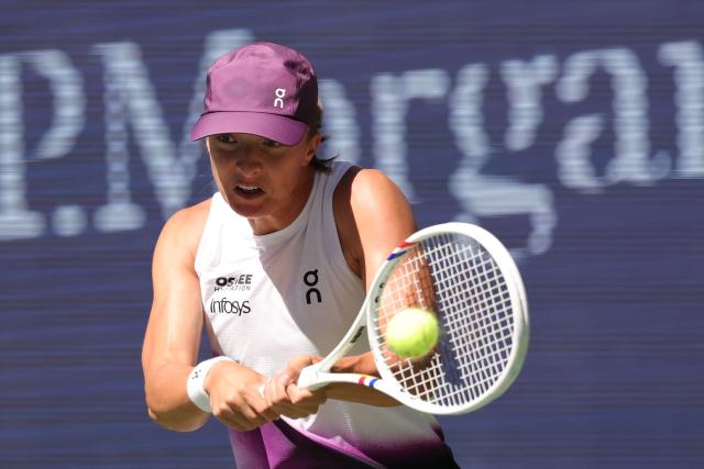 Poland's Iga Swiatek hits a return against China's Qinwen Zheng during their women's singles round of 16 tennis match on day nine of the US Open tennis tournament at the USTA Billie Jean King National Tennis Center in New York City on September 7, 2026. (Photo by KENA BETANCUR / AFP)