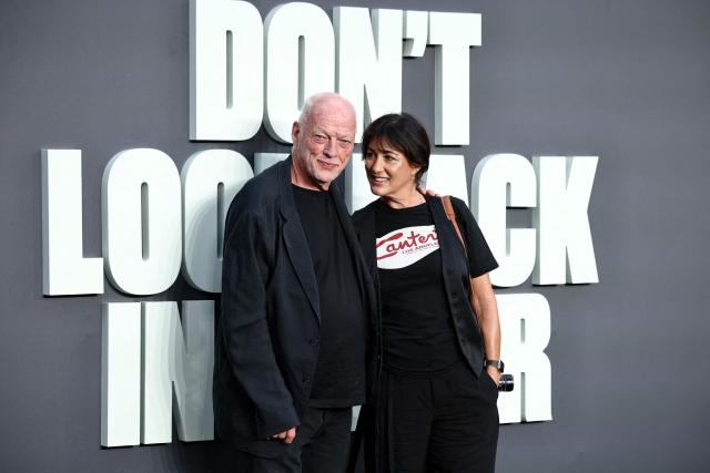 British Musician and lead guitarist with Pink Floyd, David Gilmour, and his wife Novelist Polly Samson pose upon arrival on the red carpet for the UK premiere of the film 'Oasis: Don't Look Back In Anger', in Leicester Square in central London on September 7, 2026. (Photo by Henry NICHOLLS / AFP)